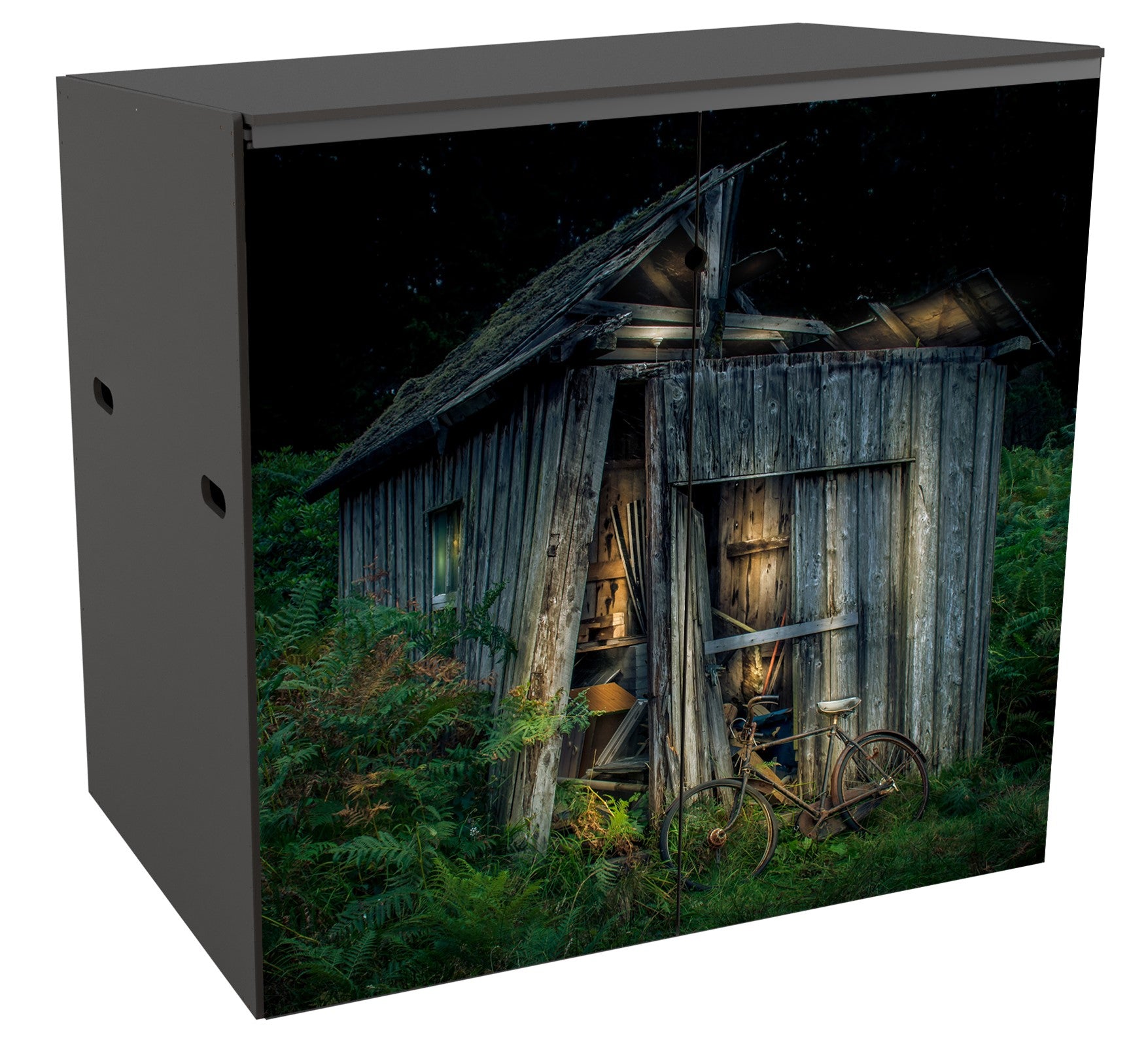 A wheelie bin store for 2 bins.  Across the 2 doors is an image of a grey wooden  garden shed in a highly dilapidated condition. It sits in the centre of the frame against a black starry sky and a bed of bracken. It is lit in a romantic sort of way to make the texture of the wood look interesting and the bracken to be a vibrant green although it is clearly night. Propped against the old shed there is an old-fashioned bicycle with a whitish leather saddle.