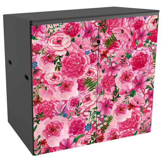 A  double storage unit showing a mass of large-scale, stylized blooms done in a hand-painted style in a range of pinks ranging from very pale to shocking pink. Many of the blooms are roselike, with lighter petals on the outer edges and deepening in shade towards the centres. The whole effect is like a giant densely-packed  bouquet. To add balance there is the occasional frond of fernlike greenery and delicate pale mimosa like sprigs as well as tiny blue flowers.