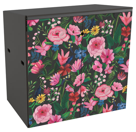 A front view of a double garden storage unit suitable for 2 bins. Mainly a variety of blowsy pink blooms as well as some yellow dandelion type flowers, and smaller blue flowers with springs of green foliage in a handpainterly style reminiscent of painted canal barges. The dark grey background makes the colours pop.  